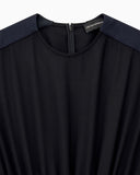 Sleeveless dress with a gathered bodice and front pleat